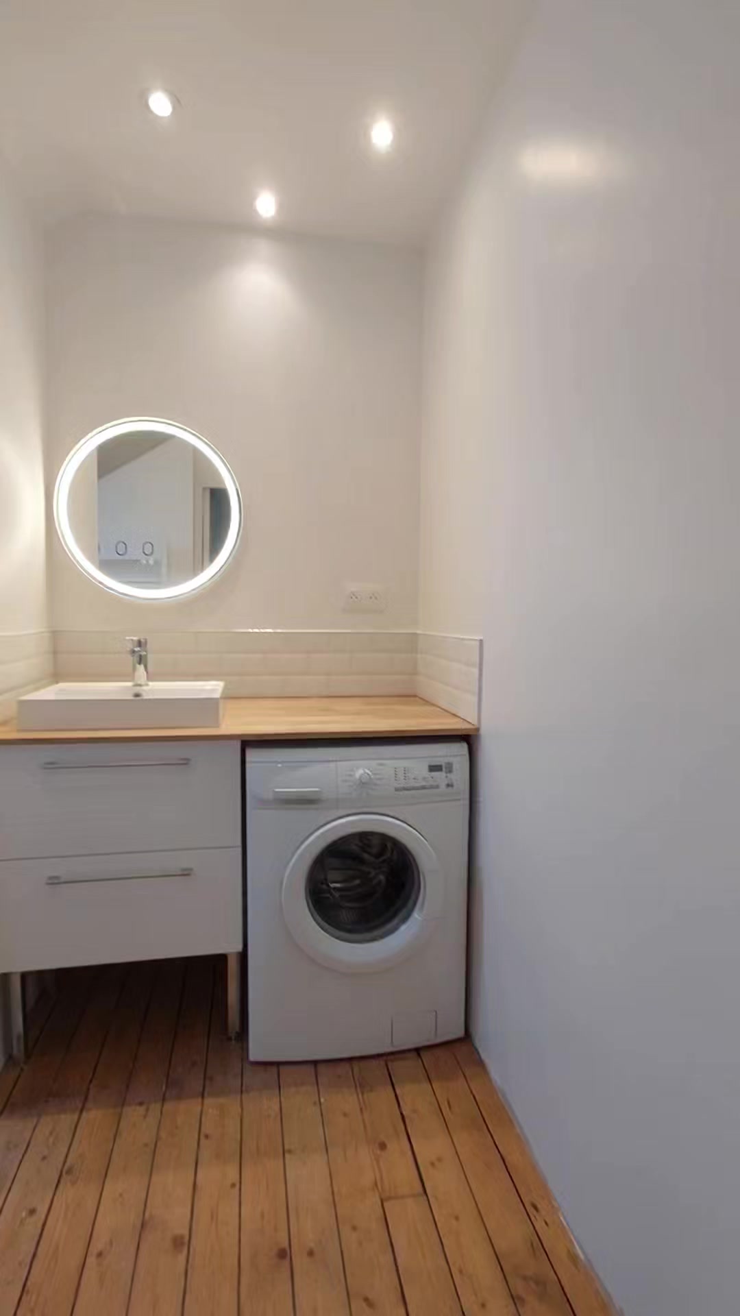 Photo réelle — Meuble vasque et espace lave-linge à Localisation non précisée
